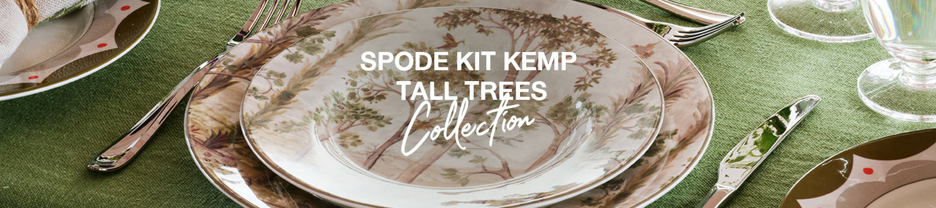 Spode Kit Kemp dinnerware featuring delicate tree and woodland motifs in soft earth tones, styled with whimsical rabbit figurine and elegant table setting